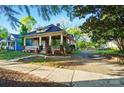 Brick home with inviting front porch and a driveway leading to the backyard at 247 W Park Ave, Charlotte, NC 28203