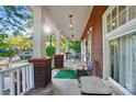 Inviting front porch with brick columns and space for outdoor seating to enjoy the view at 247 W Park Ave, Charlotte, NC 28203