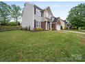 Charming two-story home with gray siding, brick accents, a well-manicured lawn, and mature trees at 253 Memory Ln, Rock Hill, SC 29732