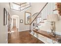 Stunning foyer with wood floors, a large mirror, and staircase leading to the upper level at 3005 Dream Catcher Cir, Fort Mill, SC 29715