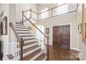 Grand foyer featuring a winding staircase, wood floors, and double doors at 3005 Dream Catcher Cir, Fort Mill, SC 29715