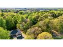 Aerial view of a charming home nestled among lush green trees, offering privacy at 3232 47Th Avenue Ne Pl, Hickory, NC 28601