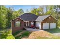 Charming brick home featuring an attached two-car garage and a comfortable patio area at 3232 47Th Avenue Ne Pl, Hickory, NC 28601