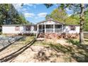 Charming single-story home boasts a screened porch and lush landscaping in a serene setting at 3536 Minnow Bridge Rd, Carlisle, SC 29031