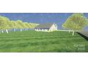Scenic shot showcasing a bright, well-maintained home on a large lot with lots of trees at 3605 Libby Ln, Midland, NC 28107