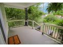 View from a home's covered front porch with wooden railings and iron accents, offering a neighborhood view at 409 N Apple St, Gastonia, NC 28054