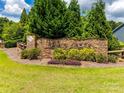 Community entrance sign amidst lush landscaping, showcasing the name Hawk's Creek on a stone wall at 487 Hawks Creek Pkwy, Fort Mill, SC 29708
