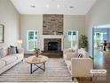 Bright living room with stone fireplace, hardwood floors, and lots of natural light at 5104 Shannamara Dr, Matthews, NC 28104
