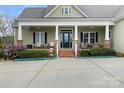 Charming front porch with brick accents and comfortable seating area at 557 Luther Dr, Iron Station, NC 28080