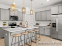 Modern kitchen featuring gray cabinetry, stainless steel appliances, and a stylish island with seating at 604 Station St # 40, Clover, SC 29710