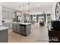 Open-concept kitchen with a large island, stainless steel appliances, and seamless flow to dining and living areas at 604 Station St # 40, Clover, SC 29710
