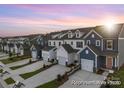Street view displaying rows of new townhouses, each with a one-car garage and manicured lawns at 604 Station St # 40, Clover, SC 29710