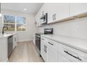 Bright kitchen features white cabinetry, stainless steel appliances, and a subway tile backsplash at 628 Old Salisbury Rd, Statesville, NC 28677