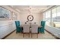 Formal dining room featuring stylish chairs, modern lighting fixture, and large window with natural light at 7035 Butternut Oak Ter, Huntersville, NC 28078