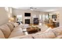 Bright living room with a cozy fireplace, hardwood floors, and comfortable sectional sofa at 78090 Rillstone Dr, Lancaster, SC 29720