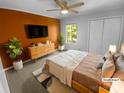 Cozy staged bedroom with ample natural light, a ceiling fan, closet, and a queen-size bed at 8000 Briardale Dr, Charlotte, NC 28212