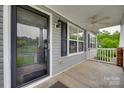 A inviting porch with a fan, gray siding and white railings at 835 Holdcroft Ln, Rock Hill, SC 29730