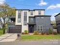 Contemporary two-story home showcasing modern design and landscaping with a garage and outdoor deck at 913 Van Every St, Charlotte, NC 28205