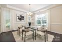 Bright dining room showcasing a modern chandelier and a large window with bright natural light at 1005 Argentium Way, Waxhaw, NC 28173