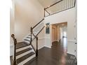 Spacious foyer with dark wood floors, a staircase, and a view into the hallway at 1005 Argentium Way, Waxhaw, NC 28173