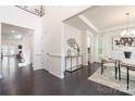 Open foyer featuring dark wood floors, and trim, flowing to dining and living spaces at 1005 Argentium Way, Waxhaw, NC 28173