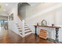 Spacious hallway features hardwood floors, wainscoting accents, and a staircase leading to the upper level at 10072 Fox Trotter Ln, Midland, NC 28107
