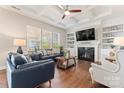 Bright living room boasts a fireplace, coffered ceilings, and hardwood floors at 10072 Fox Trotter Ln, Midland, NC 28107