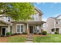 Charming townhome featuring a covered porch, neutral siding, and well-maintained landscaping at 1013 Laparc Ln, Indian Trail, NC 28079