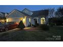 Charming two-story home with attached garage and welcoming front yard at night at 10202 Orchard Grass Ct, Charlotte, NC 28278