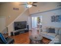 Inviting living room with vaulted ceilings, hardwood floors, and cozy seating arrangement, perfect for relaxation at 10202 Orchard Grass Ct, Charlotte, NC 28278
