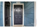 Charming blue home featuring a classic black front door with white trim at 1033 Southwest Dr, Davidson, NC 28036
