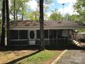 This cozy home features a screened porch, perfect for enjoying the outdoors at 108 Captains Ct # B116, Mount Gilead, NC 27306