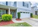 Inviting two-story home with a stone-accented entrance, attached garage, and well-maintained landscaping at 1144 Spicewood Pines Rd, Fort Mill, SC 29708