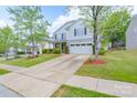Two-story home featuring a two-car garage, long driveway, and attractive landscaping at 1144 Spicewood Pines Rd, Fort Mill, SC 29708