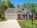 Beautiful single story home with a two car garage and inviting front porch at 11778 Crossroads Pl, Concord, NC 28025