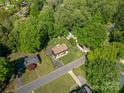 Overhead view of a well-maintained home, surrounded by lush greenery, mature trees and street at 119 Meadowbrook Ln, Davidson, NC 28036