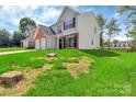 Two-story home with brick and vinyl siding, offering a spacious two-car garage and a well-maintained lawn at 1216 Stourbridge Lion Dr, Charlotte, NC 28213