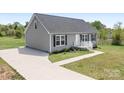 Charming single-story home with gray siding, black shutters, and a well-manicured front yard at 123 Pumice Dr, Statesville, NC 28625