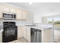 Modern kitchen featuring white cabinets, stainless steel appliances, and subway tile backsplash at 123 Pumice Dr, Statesville, NC 28625