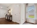 Welcoming foyer with hardwood floors, neutral walls, and decorative console table at 14018 Wilson Mac Ln, Charlotte, NC 28278