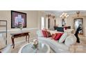 Elegant living room featuring plush seating, a chandelier, and classic decor at 141 Ivy Creek Ln, Mooresville, NC 28115