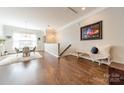 Open dining area featuring hardwood floors, natural light, modern chandelier, and decorative accents at 15133 Rocky Bluff Loop, Davidson, NC 28036