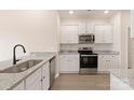 Modern kitchen featuring stainless steel appliances, granite countertops, and white cabinets at 3330 Strong Box Ln, Gastonia, NC 28052