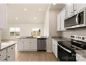 Open kitchen with stainless appliances, granite counters, and hardwood floors at 3330 Strong Box Ln, Gastonia, NC 28052