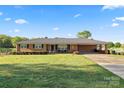 Attractive brick home with covered carport, manicured lawn, and a welcoming facade at 36984 B&C Carter Rd, New London, NC 28127