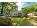 Charming single-story home with well-manicured lawn, a wooden deck, and mature trees providing ample shade at 441 Kimbrook Ct, Rock Hill, SC 29730