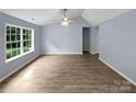 Bright living room featuring vaulted ceiling, large windows, and modern flooring at 526 Pennyfields Ln, Clover, SC 29710
