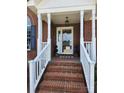 Welcoming front porch with brick steps and classic white railings, leading to an inviting entrance and charming details at 5505 Weavers Row, Gastonia, NC 28056