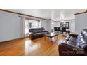 Spacious living room with hardwood floors and large window, filled with natural light at 7410 Middlebury Pl, Charlotte, NC 28212