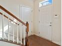 Bright entryway with wood floors, stairs to the second level, and entry door at 9618 Springholm Dr, Charlotte, NC 28278